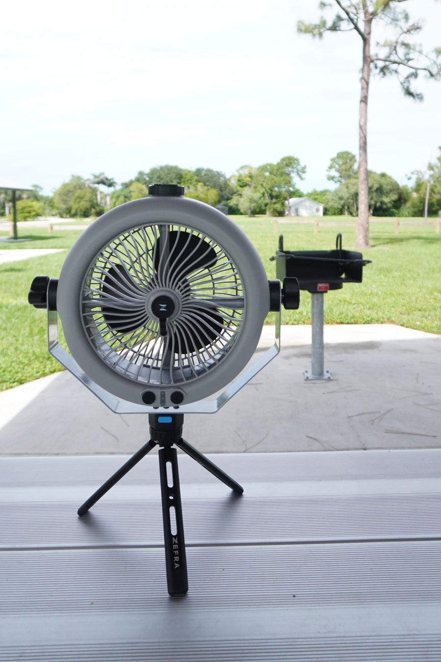 MistOne on its tripod on a picnic table at a park.